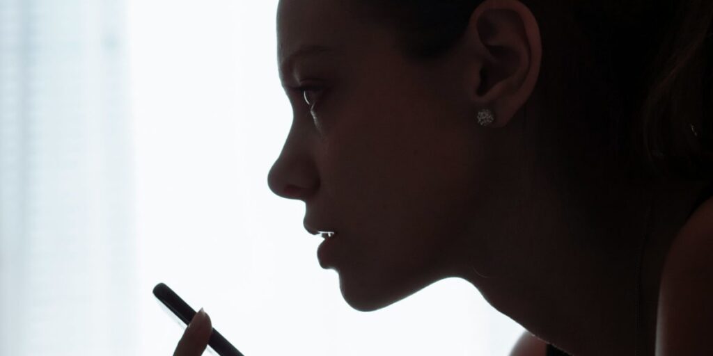 shadow of woman speaking into a phone